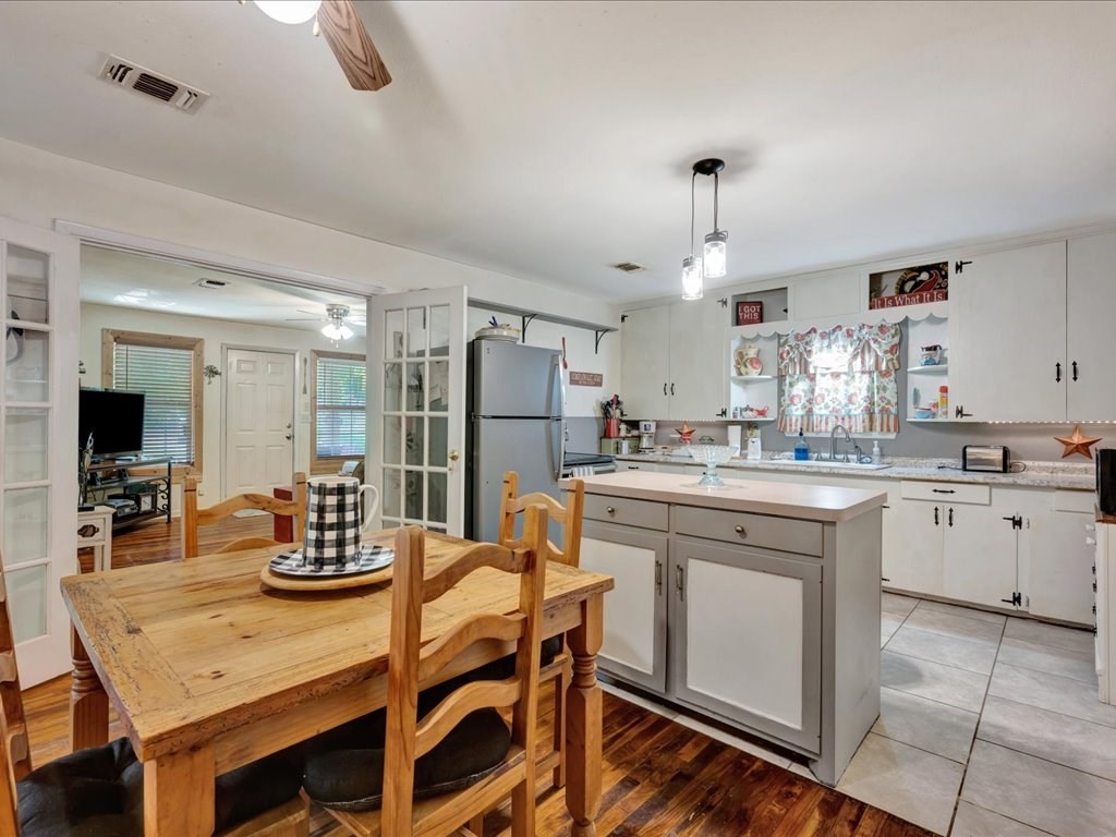 635 Oscar Berry Road Lufkin, TX 75904 - Photo 10 of 36 a kitchen with white cabinets and refrigerator