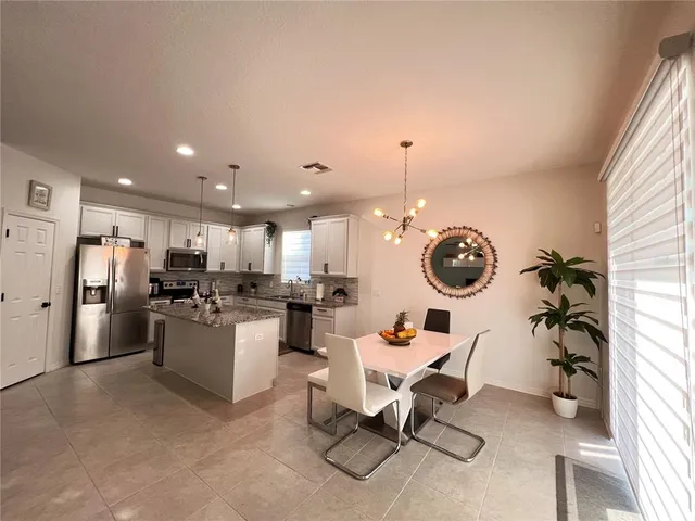 a living room with a fireplace furniture and a potted plant