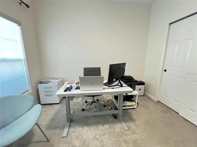 a view of a hallway with paintings on the wall