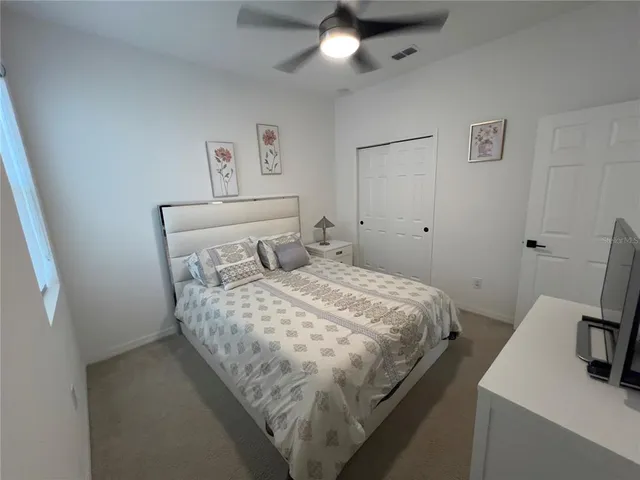 a bedroom with a bed and window