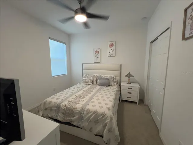 a bedroom with a bed and window