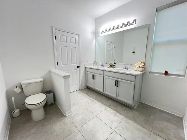 a view of a house with a big yard and large trees