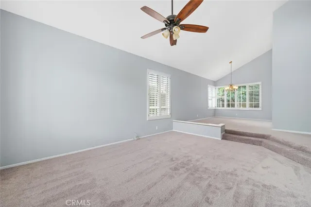 a large white kitchen with granite countertop a sink and cabinets