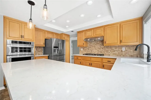 a view of an empty room with a fireplace and a window