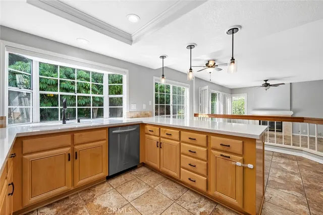 an empty room with a window and ceiling fan