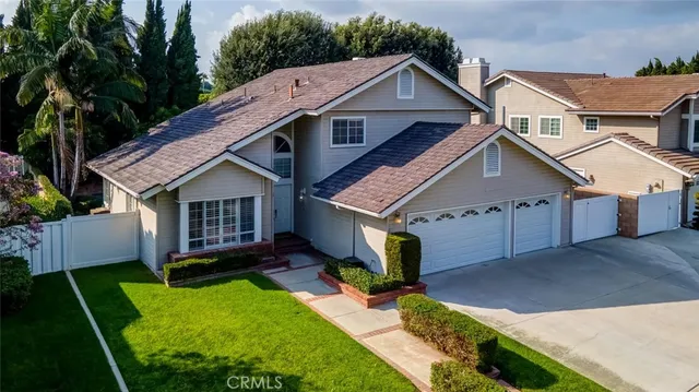 a aerial view of a house with a yard potted plants and a table