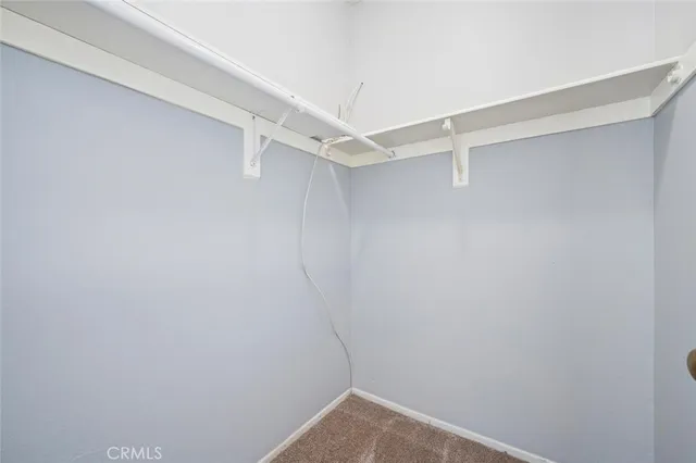 an empty room with a ceiling fan and a window