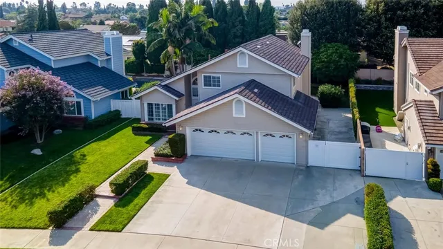 an aerial view of a house with a yard