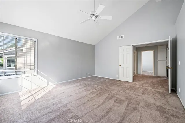 a view of a house with a yard plants and large tree