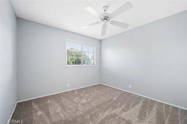 an aerial view of a house with garden space and street view