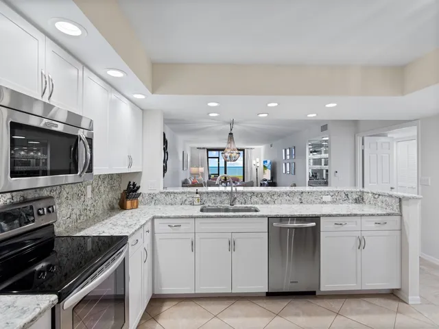 a kitchen with stainless steel appliances a refrigerator stove and microwave