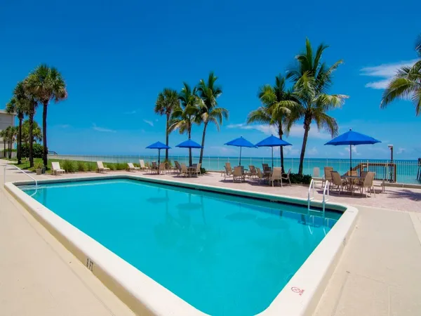 a view of a swimming pool and lounge chairs