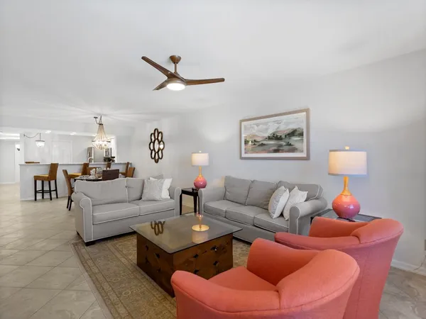 a living room with furniture a rug and a wall painting