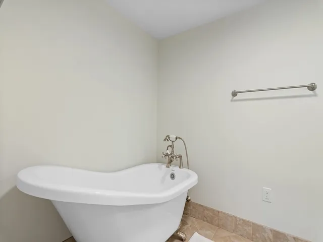 a white bath tub sitting in a bathroom