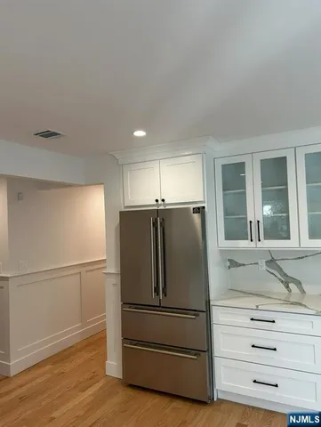 a kitchen with stainless steel appliances wooden floor and cabinet