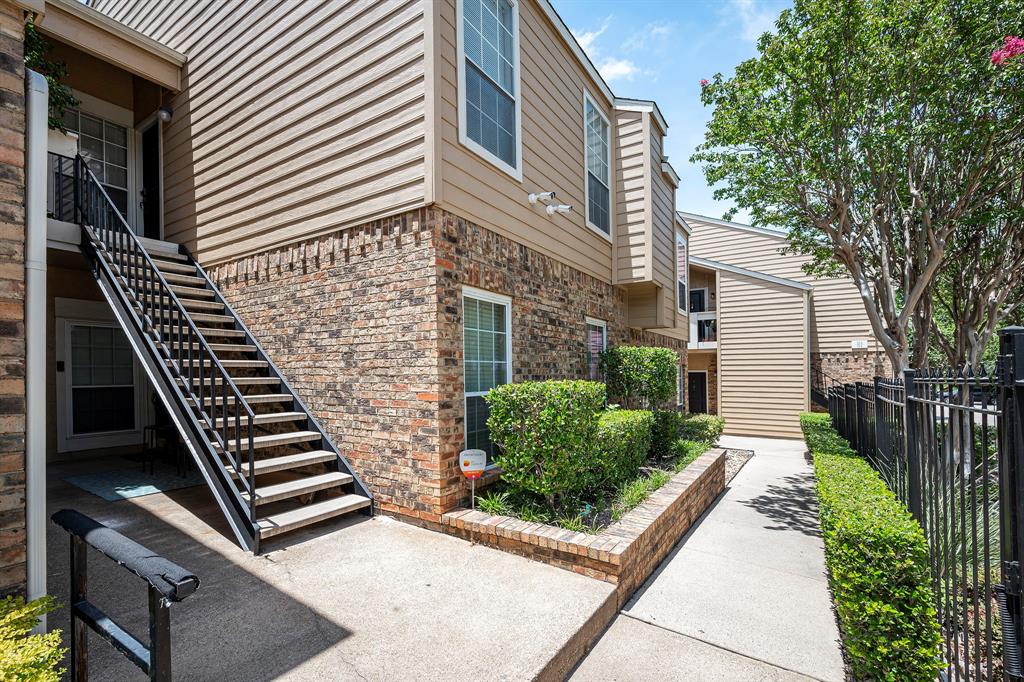 14277 Preston Road, Unit 322 Dallas, TX 75254 - Photo 1 of 1 a front view of a house with street and trees