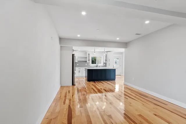 a view of a bedroom with wooden floor