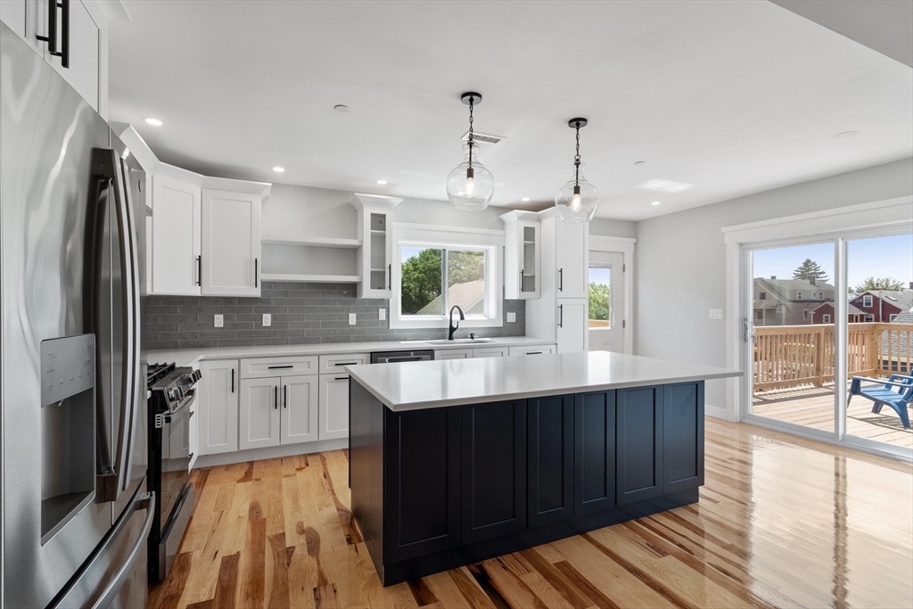 67 Essex Street, Unit 2 Salem, MA 01970 - Photo 2 of 35 a kitchen with stainless steel appliances granite countertop a sink stove and refrigerator
