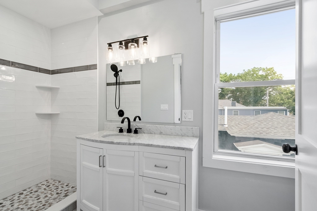 67 Essex Street, Unit 2 Salem, MA 01970 - Photo 21 of 35 a bathroom with a sink and a mirror