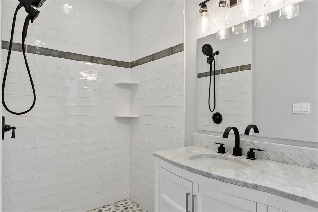 67 Essex Street, Unit 2 Salem, MA 01970 - Photo 22 of 35 a bathroom with a sink and a mirror