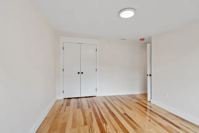 a view of room with wooden floor