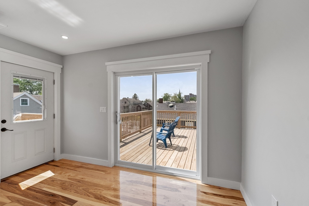 67 Essex Street, Unit 2 Salem, MA 01970 - Photo 3 of 35 a view of a livingroom with wooden floor and a floor to ceiling window