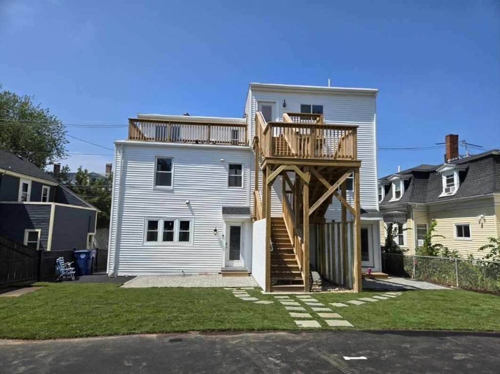67 Essex Street, Unit 2 Salem, MA 01970 - Photo 33 of 35 a front view of a house with a yard