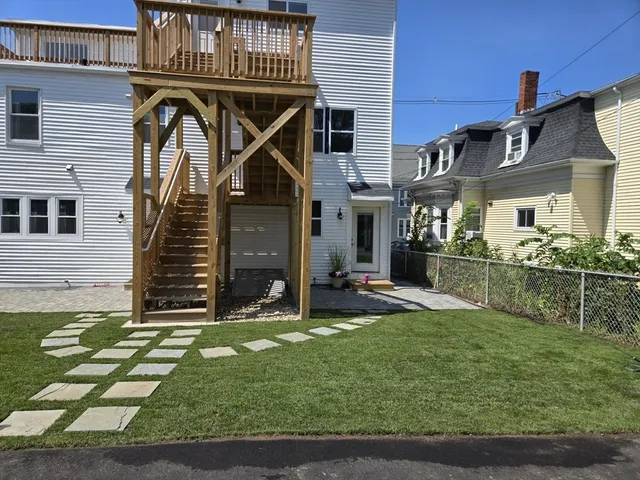 a view of a house with backyard and porch