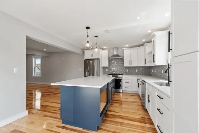 a large kitchen with cabinets a sink and a stove