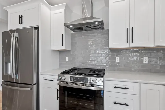 a kitchen with stainless steel appliances granite countertop a refrigerator stove and sink