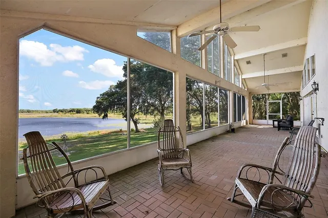 a view of a chairs and table in patio with a lake view