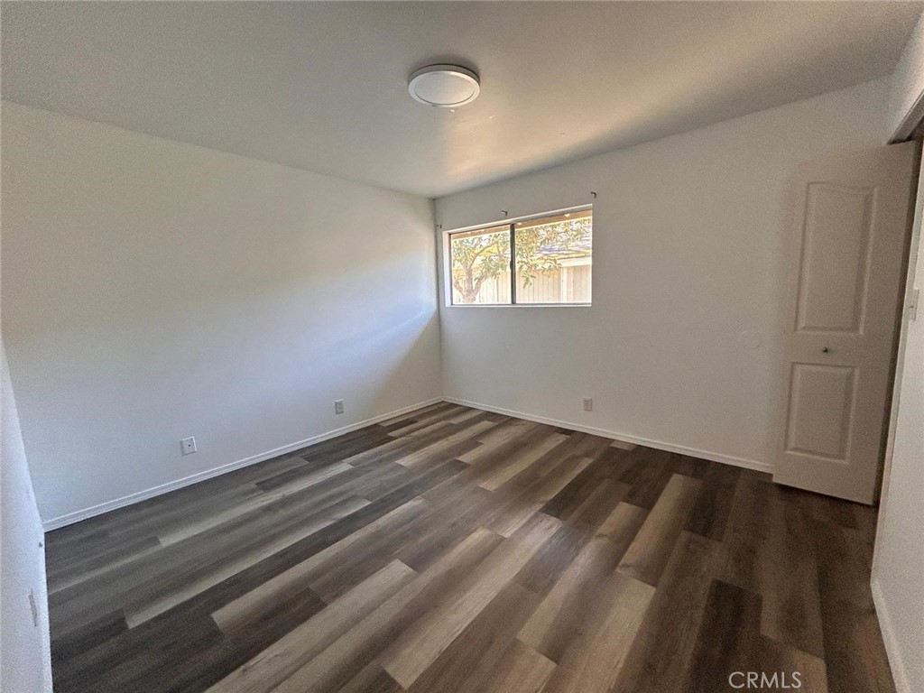 427 East Park Avenue, Unit 2 Santa Maria, CA 93454 - Photo 7 of 12 an empty room with wooden floor and windows