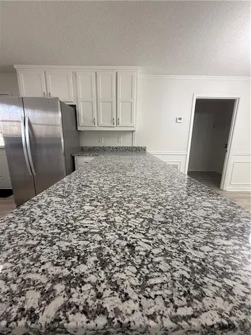 a kitchen with stainless steel appliances granite countertop a refrigerator sink and stove