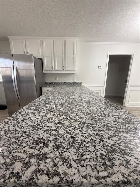 2540 Fortune Drive Dacula, GA 30019 - Photo 11 of 54 a view of a refrigerator in kitchen and wooden floor