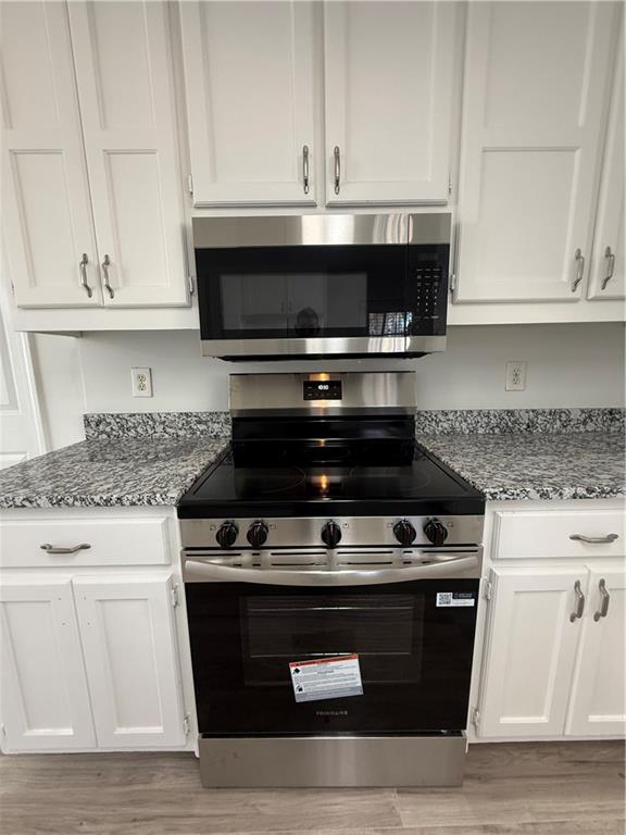 2540 Fortune Drive Dacula, GA 30019 - Photo 16 of 54 a stove top oven sitting inside of a kitchen