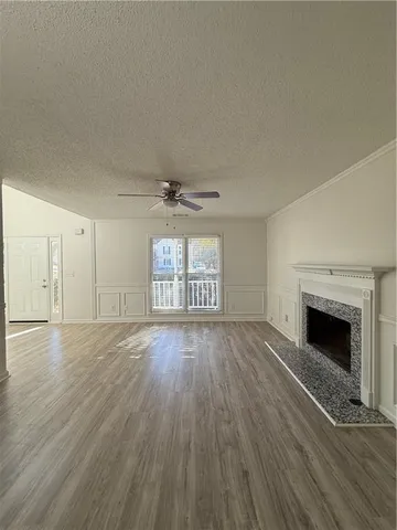 a view of a room with wooden floor and white walls
