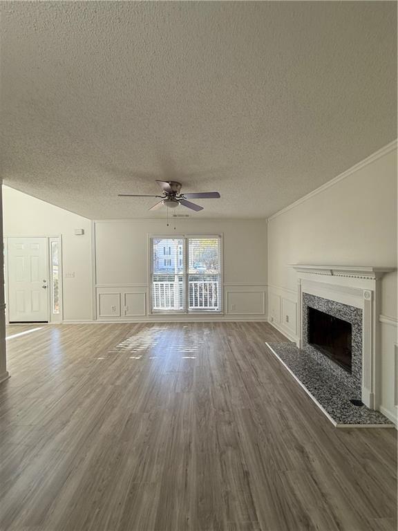 2540 Fortune Drive Dacula, GA 30019 - Photo 17 of 54 an empty room with wooden floor fireplace cabinet and windows