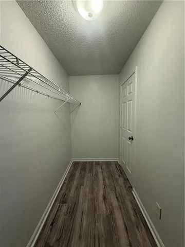 a close view of a stove a sink and dishwasher with wooden floor