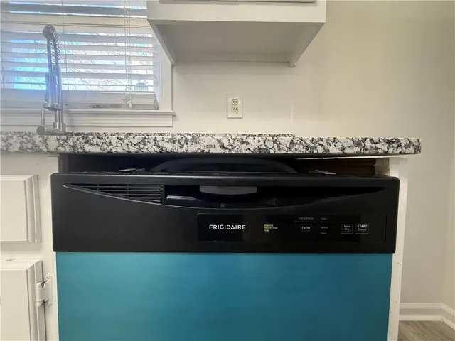 a kitchen with a sink a stove and cabinets