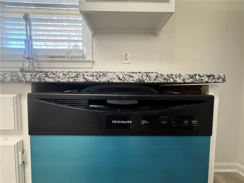 2540 Fortune Drive Dacula, GA 30019 - Photo 19 of 54 a close view of a stove a sink and dishwasher with wooden floor