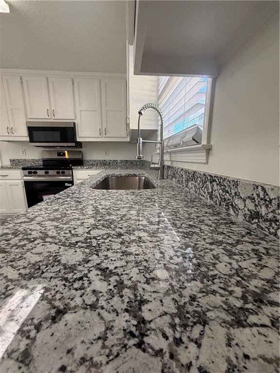 2540 Fortune Drive Dacula, GA 30019 - Photo 20 of 54 a kitchen with a sink a stove and cabinets