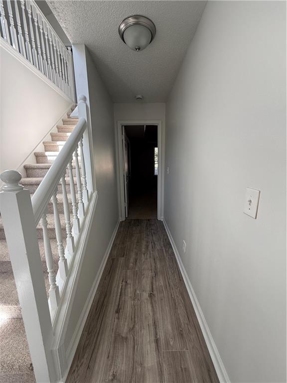 2540 Fortune Drive Dacula, GA 30019 - Photo 22 of 54 a view of a hallway view with wooden floor and staircase