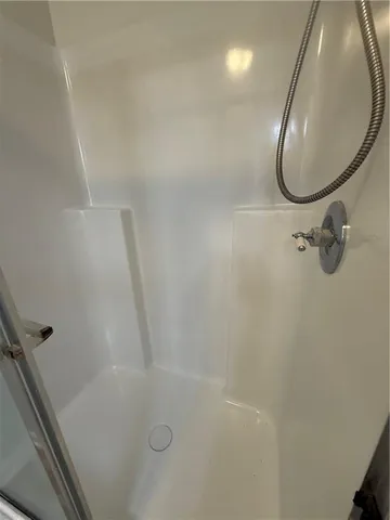 an empty room with a ceiling fan and window