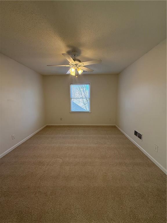 2540 Fortune Drive Dacula, GA 30019 - Photo 36 of 54 an empty room with a ceiling fan and window