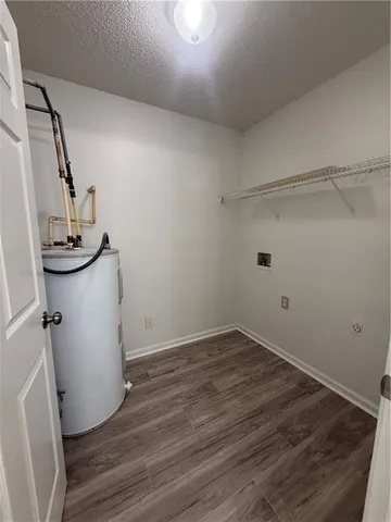 a view of a room with wooden floor