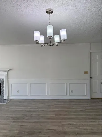 a view of an empty room with a fireplace and a window