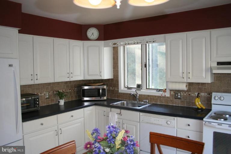 6620 Lewis Road Baldwin, MD 21013 - Photo 5 of 15 a kitchen with granite countertop a sink a stove and cabinets