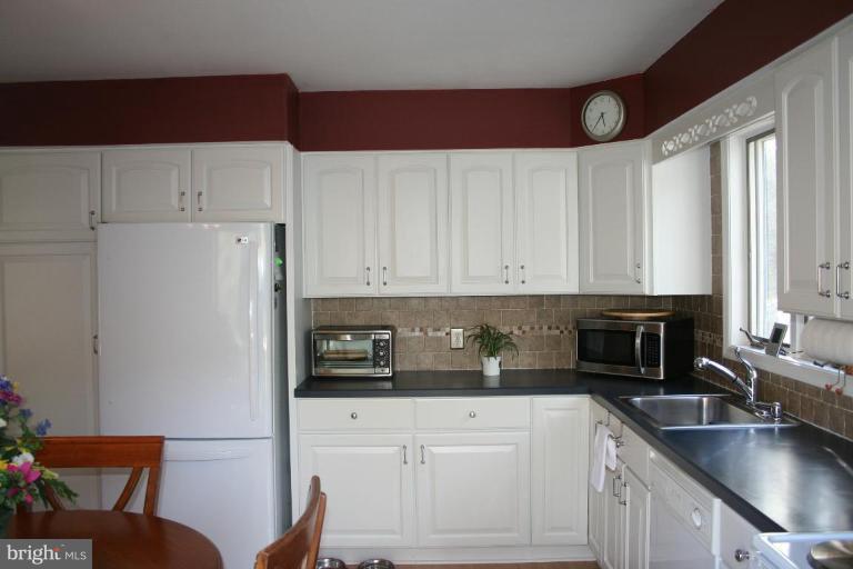 6620 Lewis Road Baldwin, MD 21013 - Photo 6 of 15 a kitchen with stainless steel appliances granite countertop a refrigerator sink and cabinets