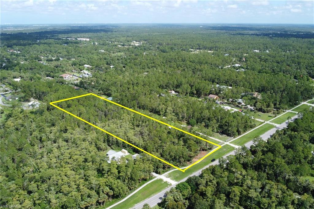 8th Street Northeast Naples, FL 34102 - Photo 5 of 10 Aerial overview of property's location featuring a heavily wooded area and property parcel outlined