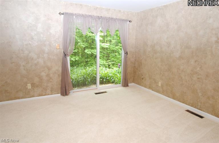 4846 Ranchwood Road Akron, OH 44333 - Photo 15 of 23 Lower Level Bedroom 3 features a sliding glass door to the back yard.